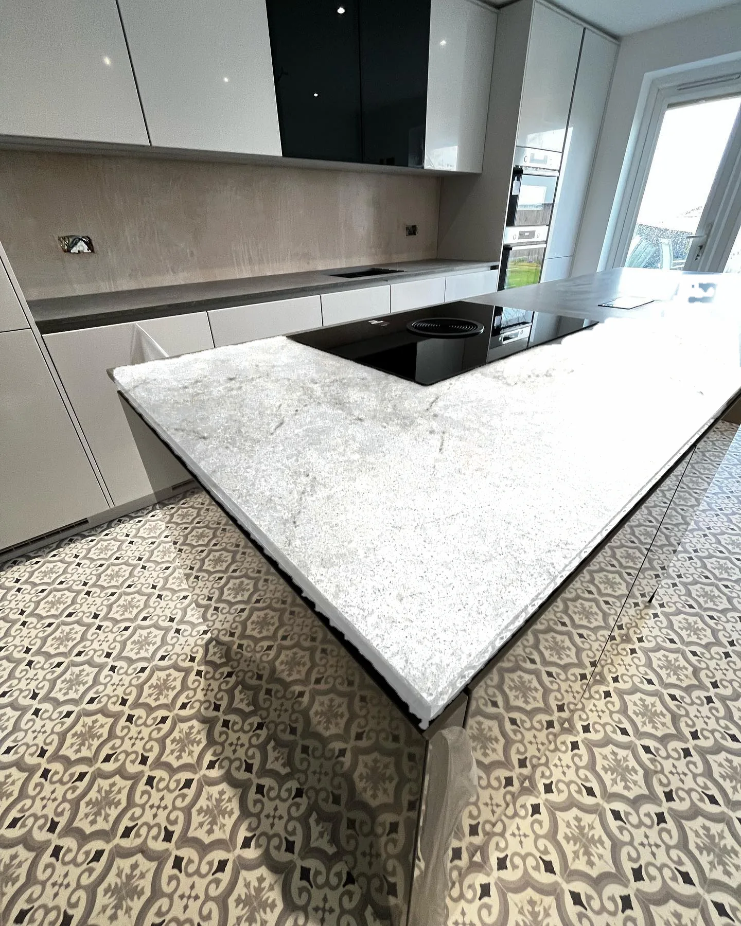 Grey island kitchen with Calacatta Nuvo worktop