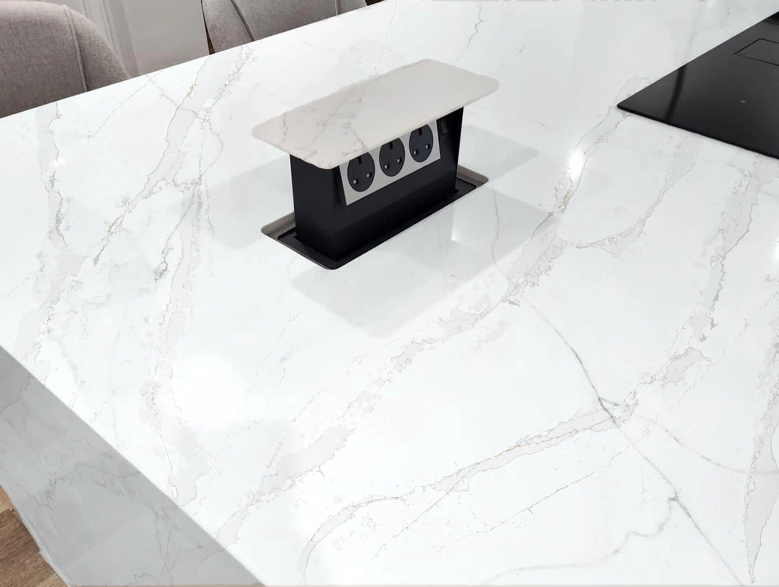White marble island, pop-up socket — visualised with Eternal Calacatta Gold quartz