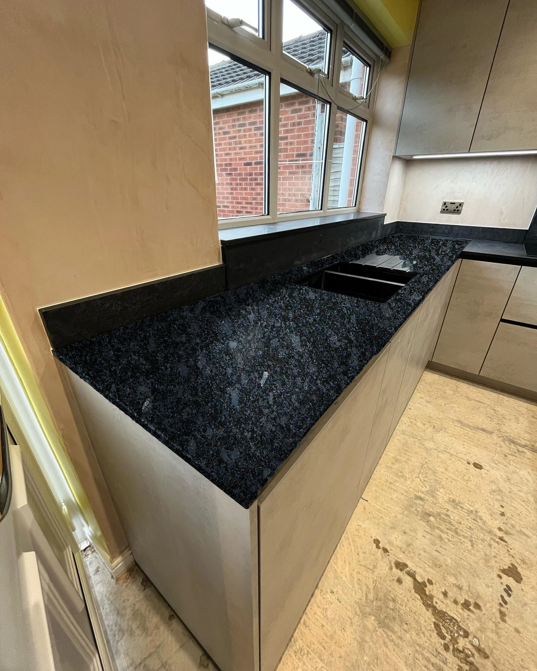 L-shaped dark worktop, sink — visualised with Steel Grey granite