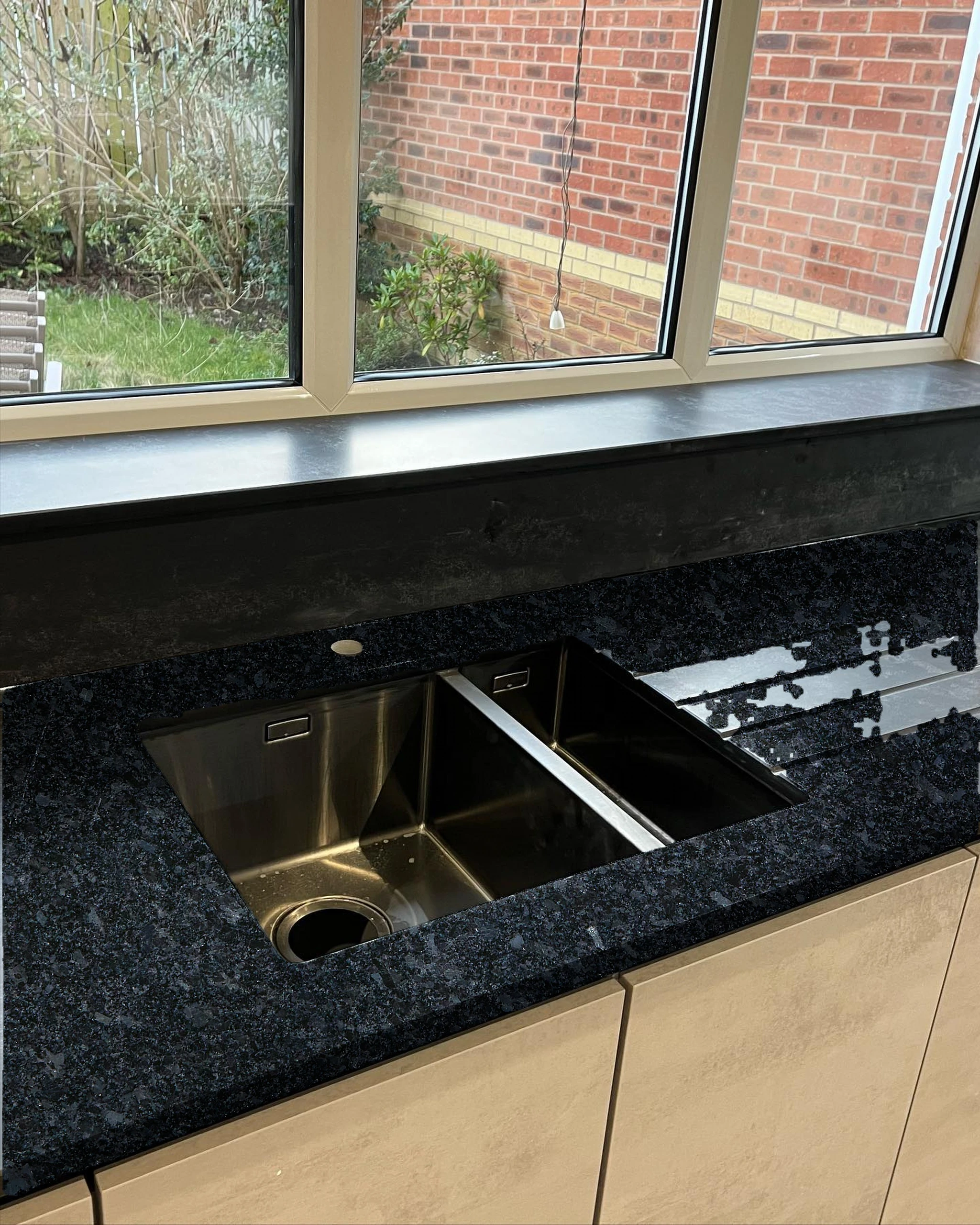 Dark worktop with sink and drainer